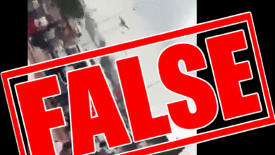 Screenshot of an X post by DJ SpoiltKid, showing a claim that an ongoing “TINUBU MUST GO!” protest is taking place in Nyanya, Abuja, with a blurred video of people gathered on a street. A large bold red “FALSE” stamp is overlaid diagonally across the post.