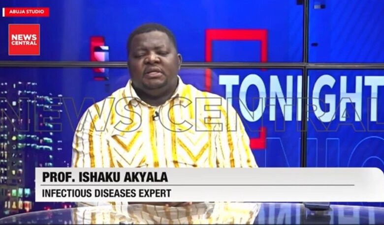 rof. Ishaku Akyala, an infectious diseases expert, wearing a yellow-and-white patterned traditional outfit while seated in the News Central television studio.