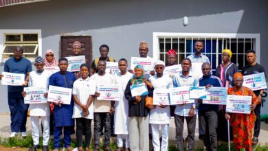 Project Sauti Civic Audio Leads pose with certificates and campaign messages after completing a FactCheckAfrica training workshop in Ilorin.